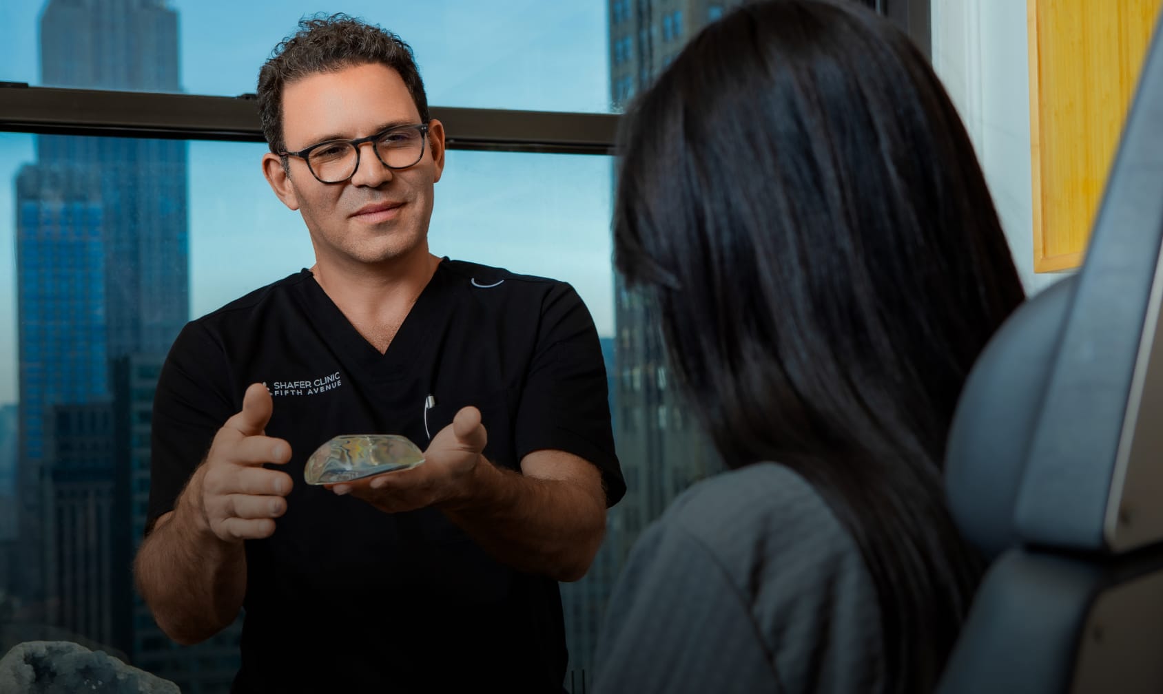 Photo of Dr. Shafer doing breast augmentation consultation with a patient