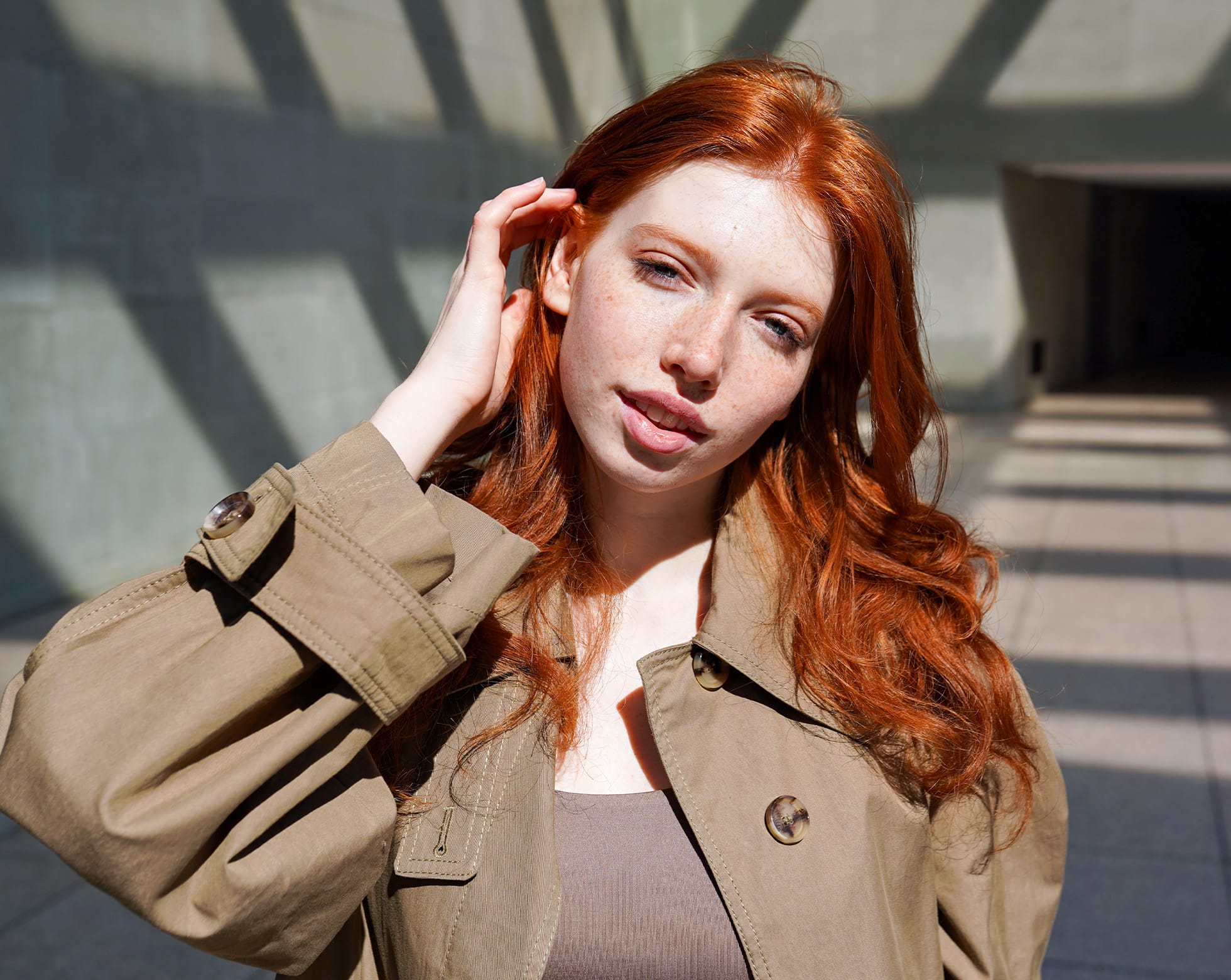 Woman brushing hair behind ear