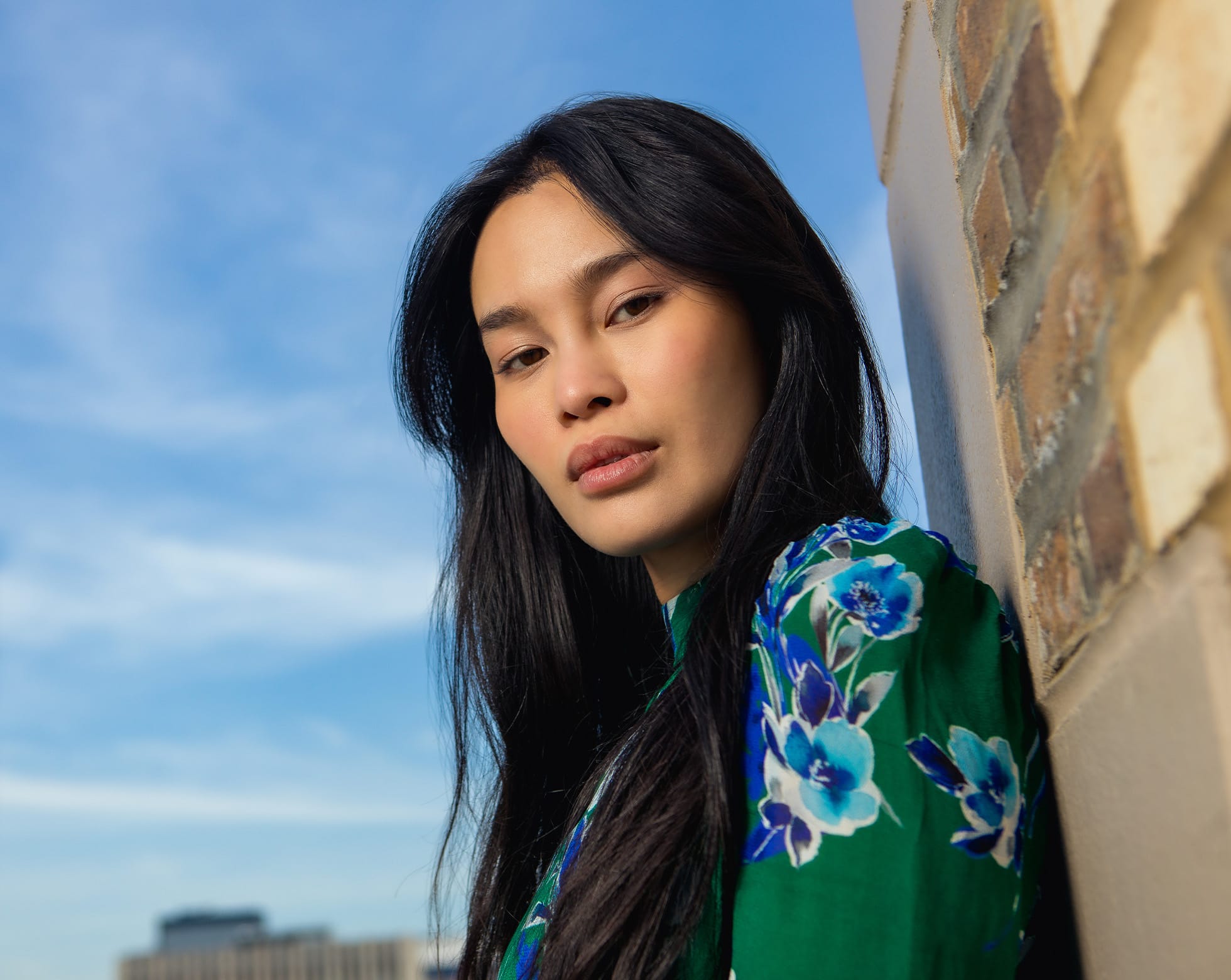 Woman leaning against a wall