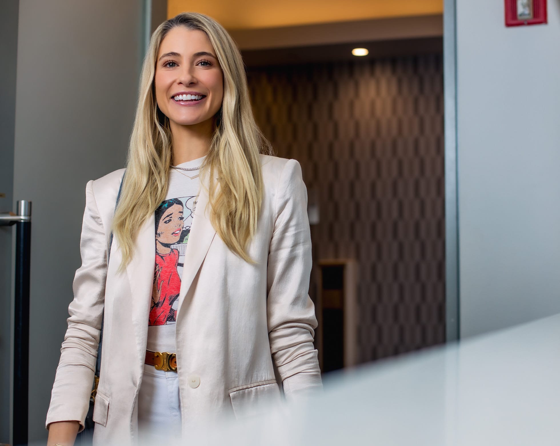 Woman smiling walking into an office