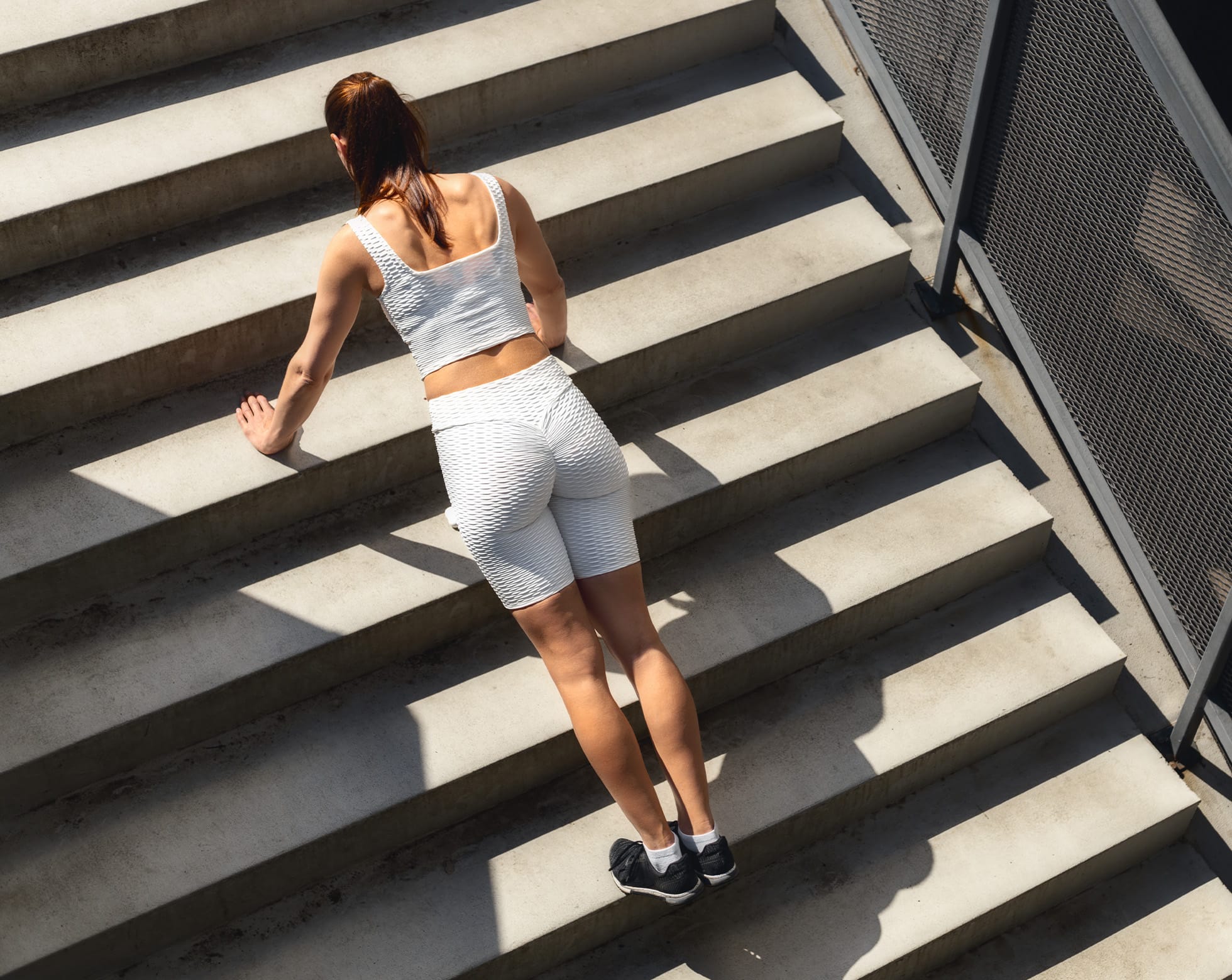 Woman doing push ups on the stairs