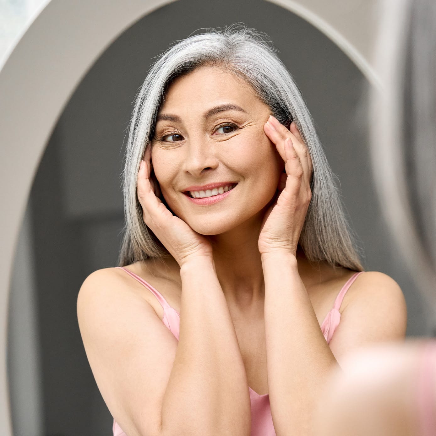 Woman smiling touching face
