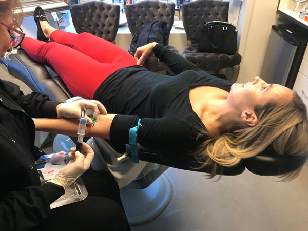 woman getting blood taken for PRP facelift 